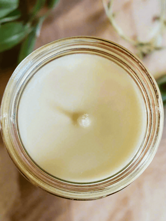 Close-up of a glass jar with a white substance inside on a light background