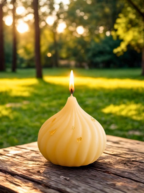 Yellow candle with a flame on a wooden surface in a park setting