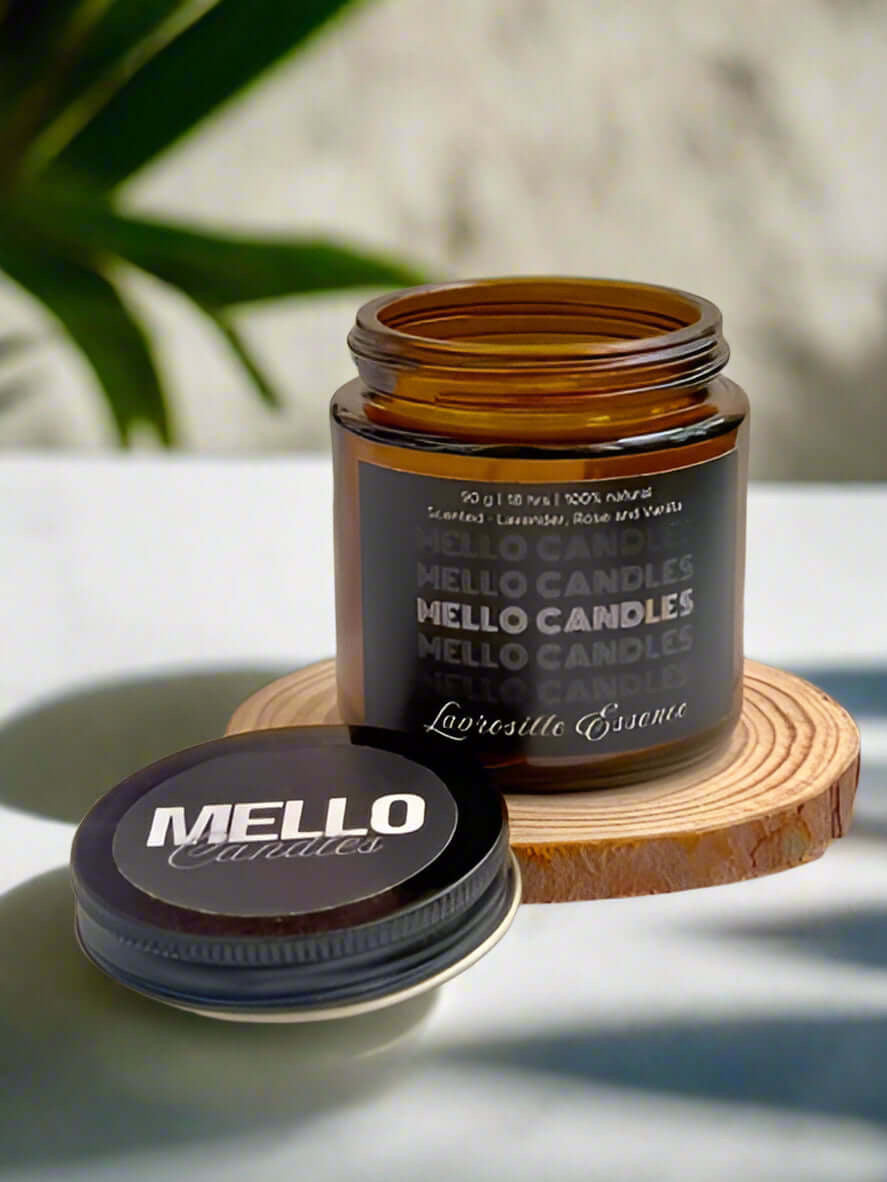 Lavrosille Essence scented candle – floral soy wax blend in glass jar placed on marble surface.
