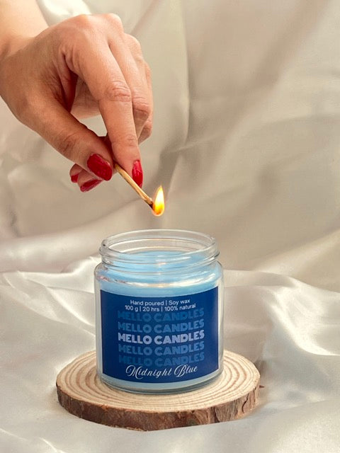 Lighting Midnight Blue Citrus candle with wooden stick – warm festive scent in glass jar.